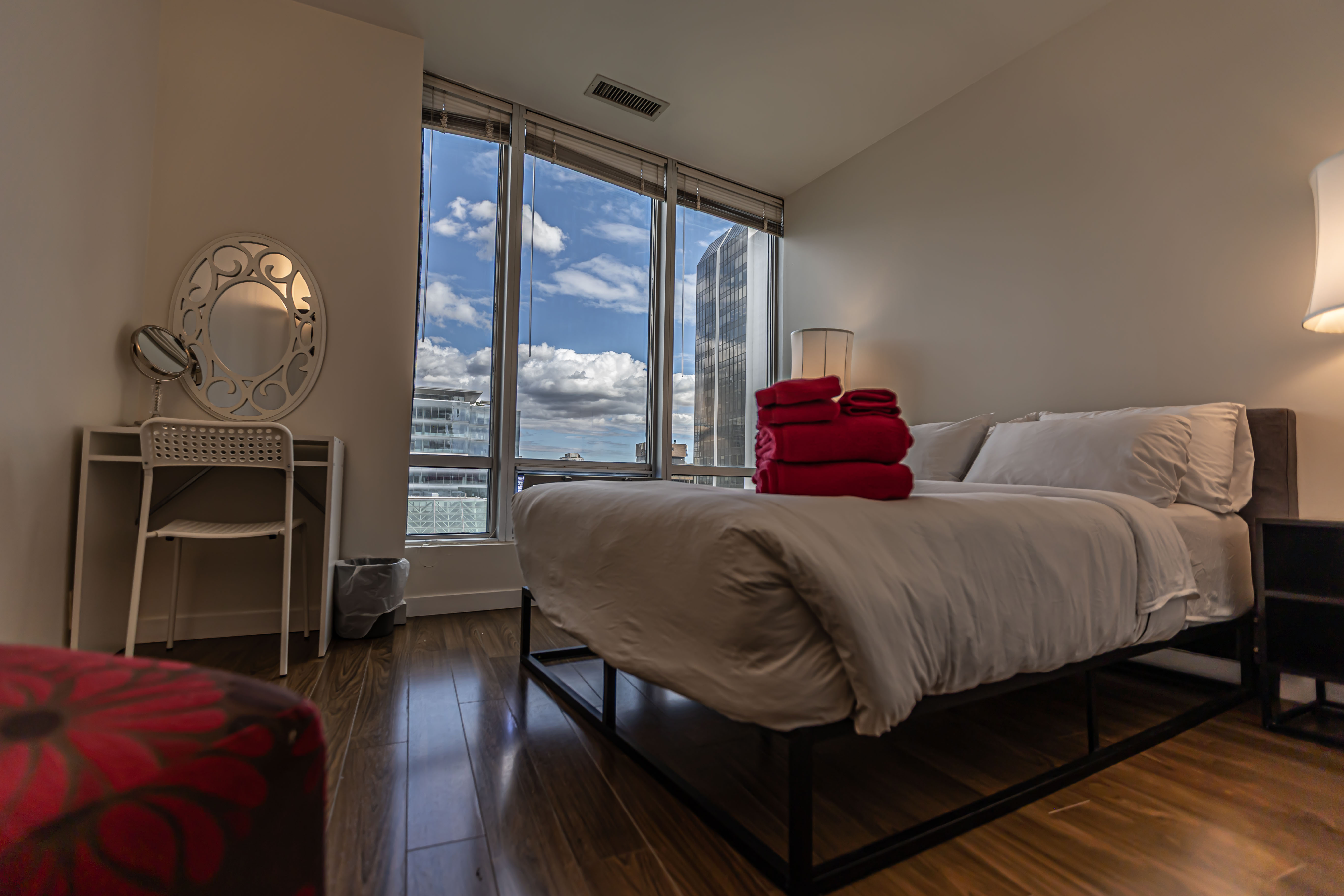 A sunlit room with floor-to-ceiling windows