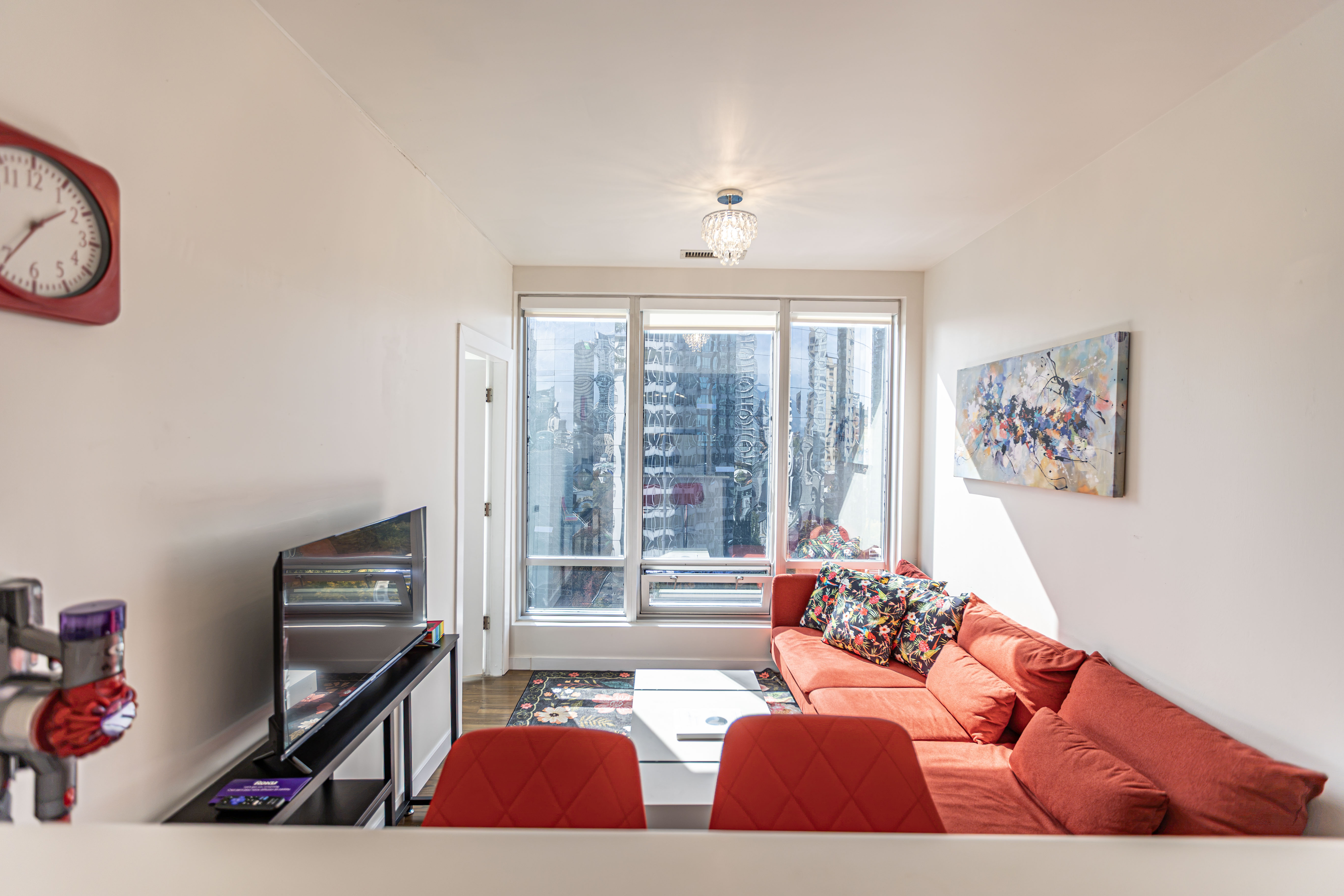Living room with a red sofa and city views